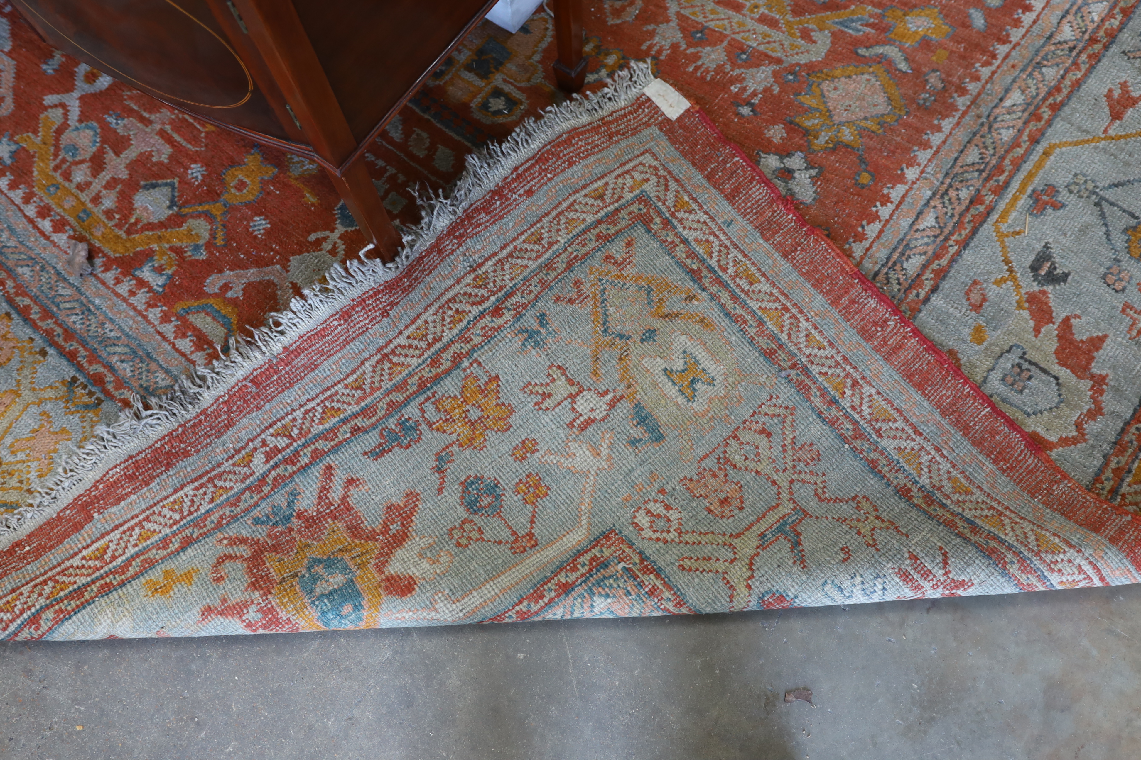 An Afghan red ground carpet, 395 x 310cm